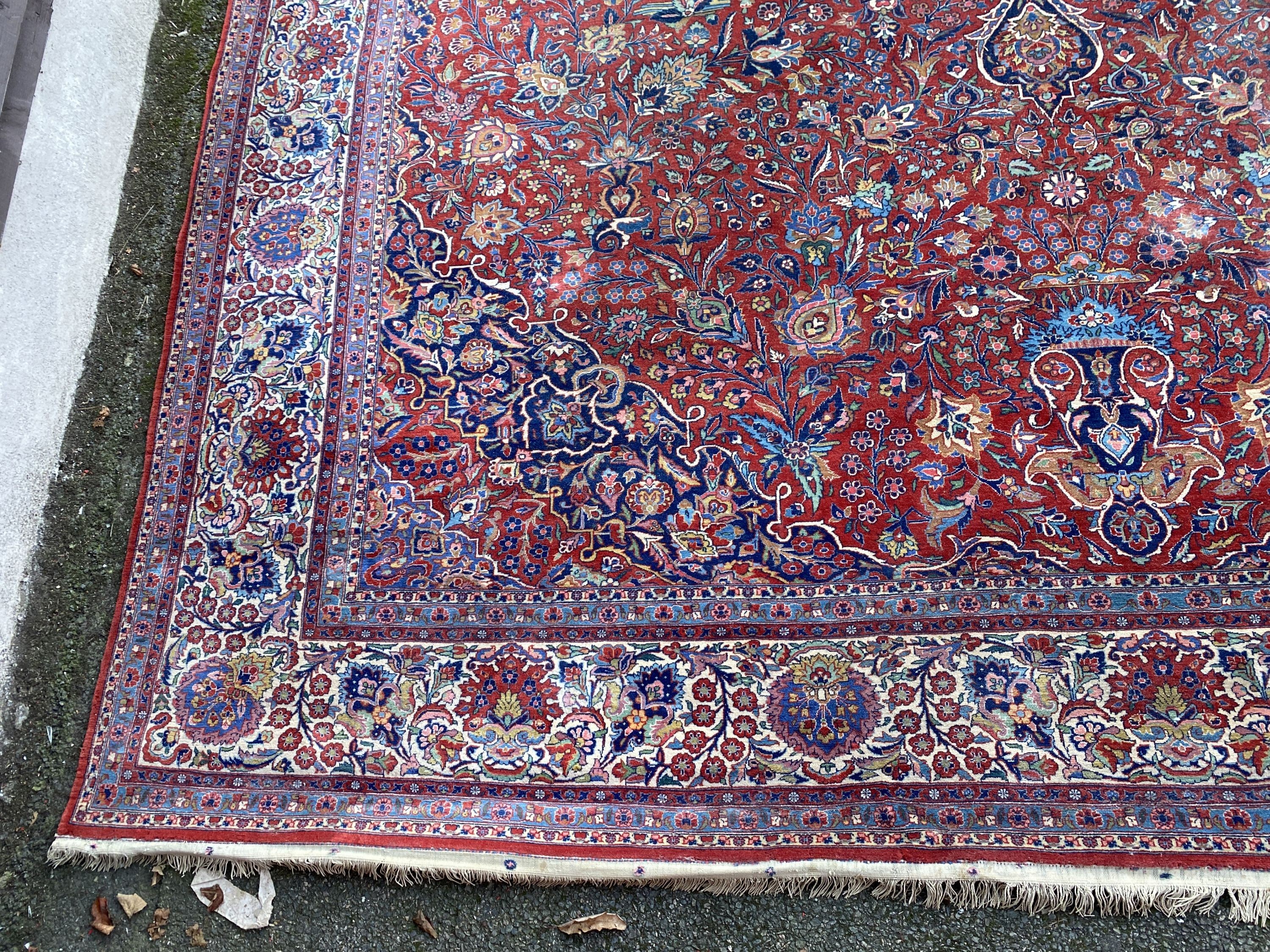 A Tabriz red ground carpet with, first half 20th century, 510cm x 355cm